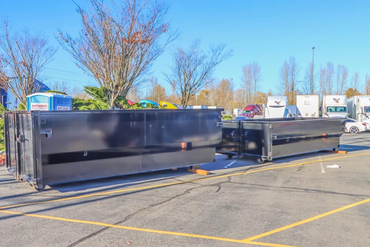 Professional dumpster rental service with roll-off container on residential driveway in Bloomsburg